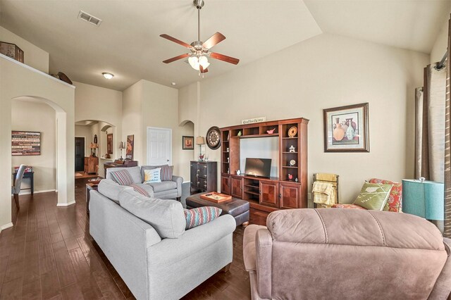 living room featuring dark hardwood / wood-style floors, high vaulted ceiling, and ceiling fan