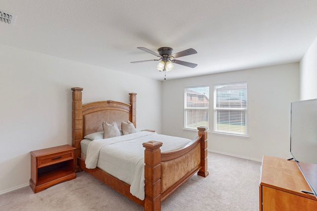 bedroom featuring light colored carpet and ceiling fan