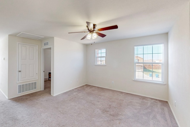 empty room featuring ceiling fan and light colored carpet