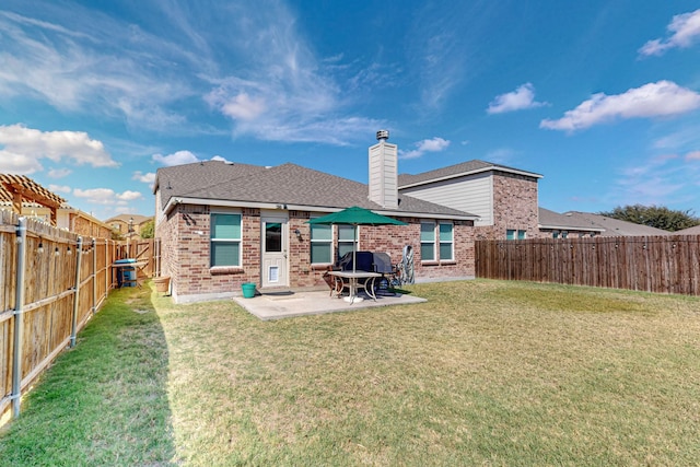 rear view of property with a patio area and a yard