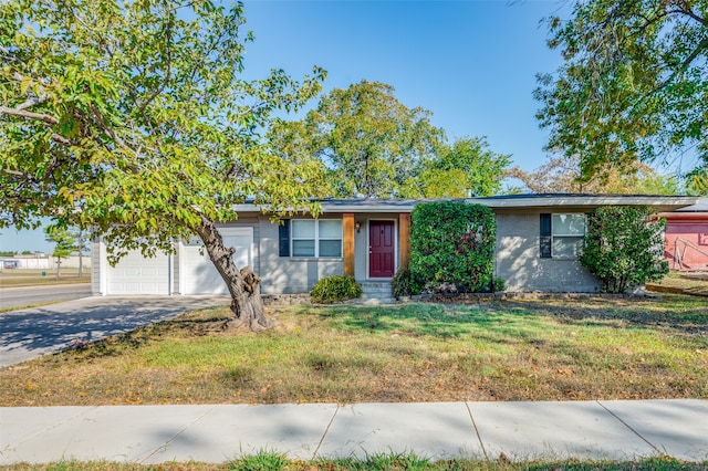 view of front facade with a front yard and a garage