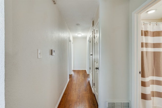 hallway with wood-type flooring