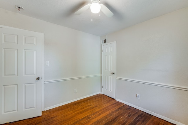 unfurnished room with dark hardwood / wood-style floors and ceiling fan