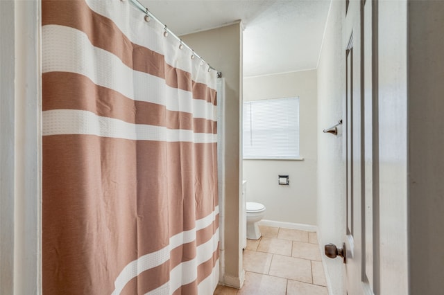 bathroom featuring toilet and tile patterned floors