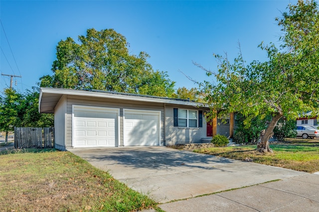 ranch-style home with a front lawn and a garage