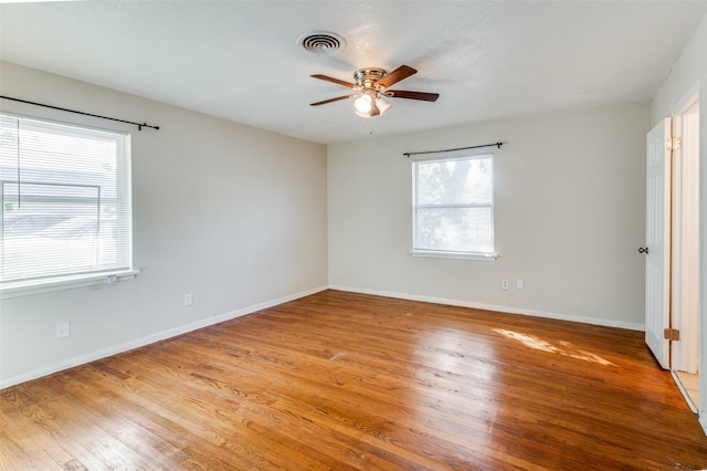 spare room with ceiling fan and wood-type flooring