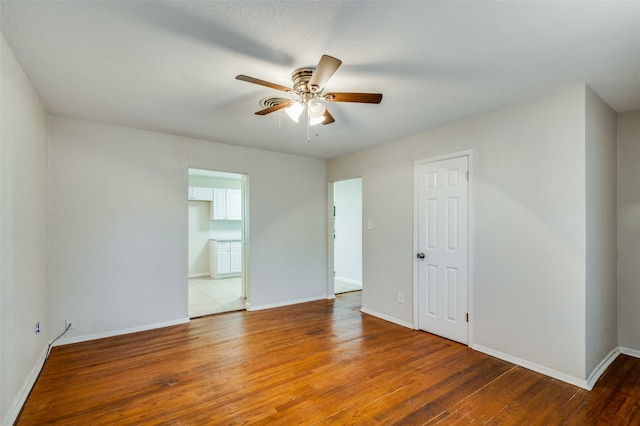 unfurnished room with wood-type flooring and ceiling fan