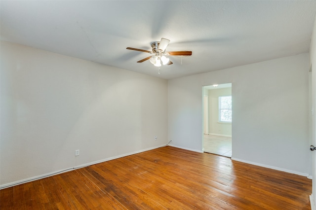 spare room with ceiling fan and wood-type flooring