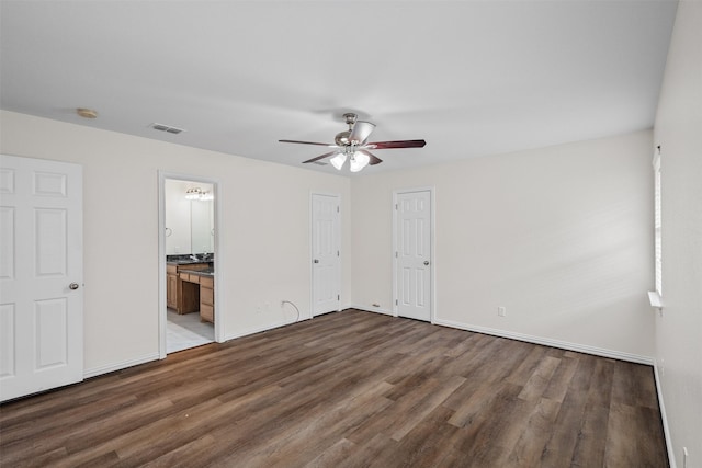 618 W Crawford St, Denison, TX 75020 - unfurnished bedroom with wood finished floors, baseboards, and ensuite bathroom