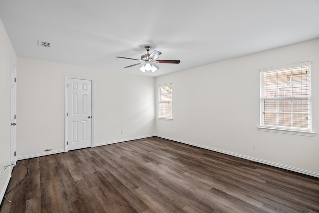 unfurnished room featuring dark hardwood / wood-style flooring, ceiling fan, and plenty of natural light