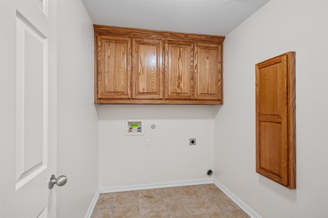 laundry room with hookup for an electric dryer, washer hookup, hookup for a gas dryer, light tile patterned floors, and cabinets