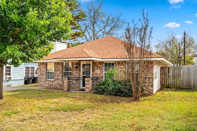 618 W Crawford St, Denison, TX 75020 - view of front facade featuring brick siding, a shingled roof, a chimney, and cooling unit