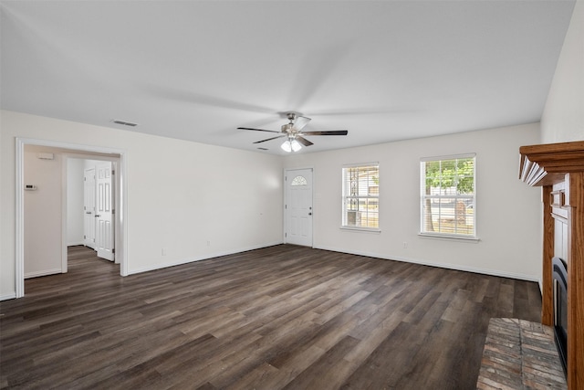 618 W Crawford St, Denison, TX 75020 - unfurnished living room with dark wood-type flooring, a ceiling fan, and baseboards