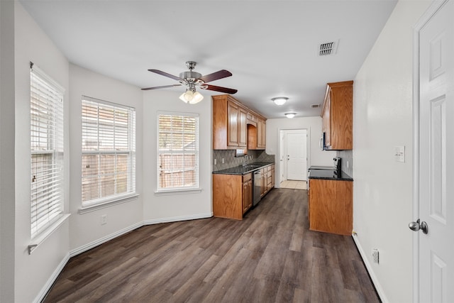 kitchen with dishwasher, dark wood-type flooring, ceiling fan, and backsplash