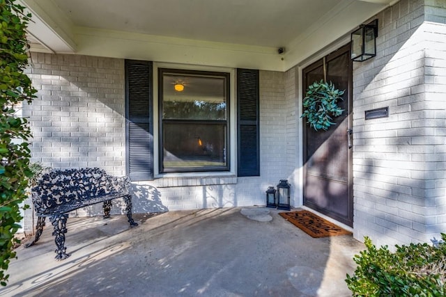 entrance to property featuring brick siding