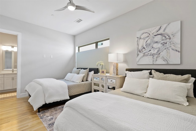 bedroom with light hardwood / wood-style flooring, connected bathroom, and ceiling fan