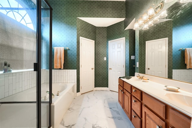 bathroom featuring a notable chandelier, a washtub, and vanity