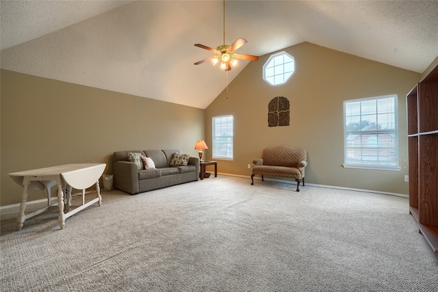 carpeted living room with high vaulted ceiling and ceiling fan