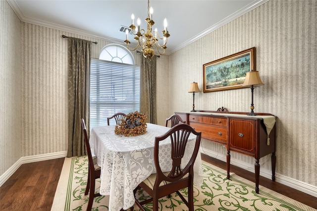 dining room with dark hardwood / wood-style flooring, a chandelier, and ornamental molding