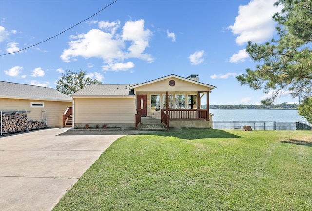 ranch-style home with a front lawn and a water view