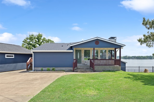 16077 Saint Paul Dr, Caney City, TX 75148 - view of front of house with a chimney, fence, a water view, roof with shingles, and a front yard