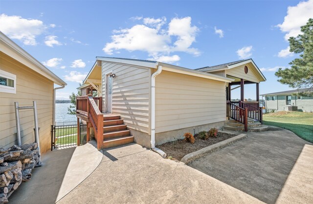 view of side of property with a patio and a water view