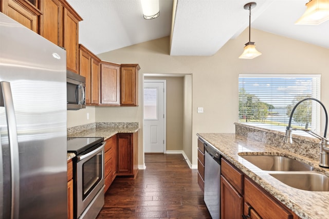 kitchen with appliances with stainless steel finishes, sink, dark hardwood / wood-style flooring, hanging light fixtures, and lofted ceiling