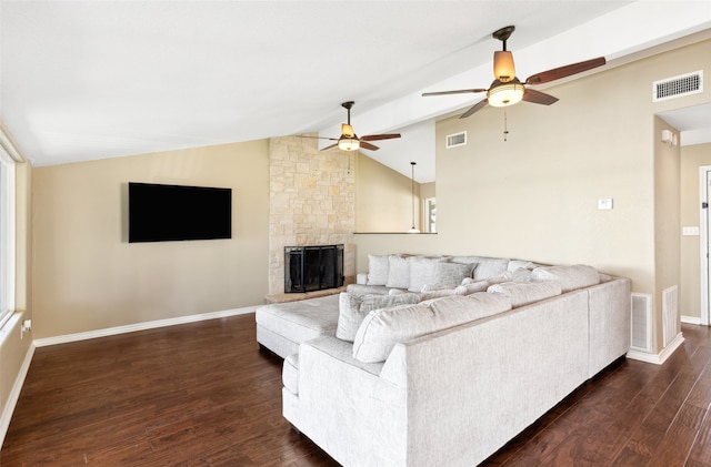 living room with lofted ceiling, a stone fireplace, ceiling fan, and dark hardwood / wood-style flooring