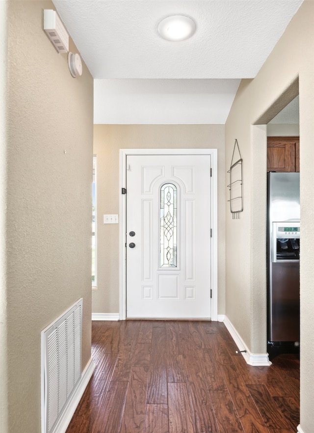 entryway featuring a textured ceiling and dark hardwood / wood-style flooring