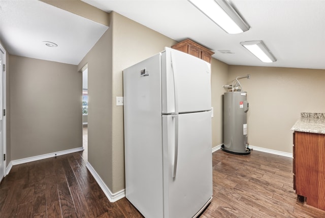 kitchen featuring lofted ceiling, electric water heater, dark hardwood / wood-style floors, and white refrigerator