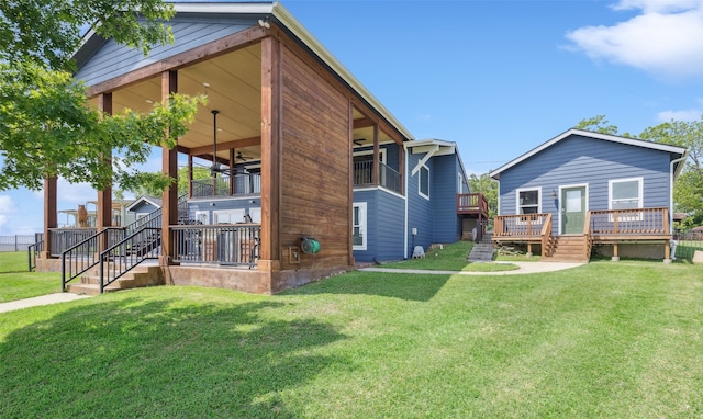 16077 Saint Paul Dr, Caney City, TX 75148 - back of house with a wooden deck, a yard, and stairs