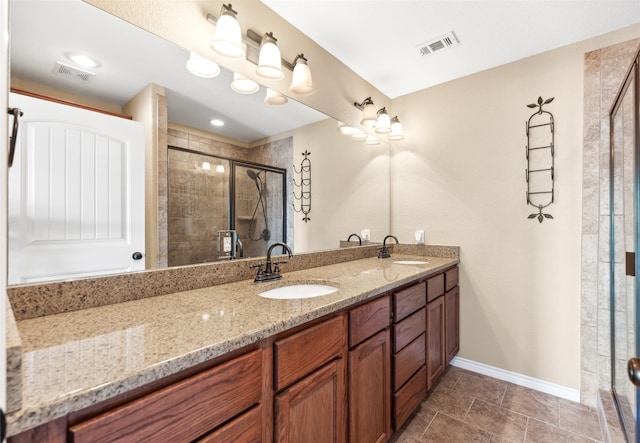 bathroom with vanity, tile patterned flooring, and a shower with door