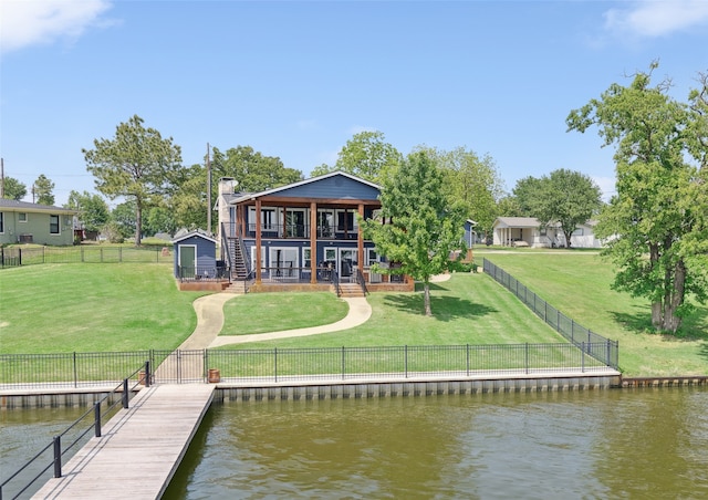 16077 Saint Paul Dr, Caney City, TX 75148 - back of house with a fenced backyard, a deck with water view, stairs, and a lawn