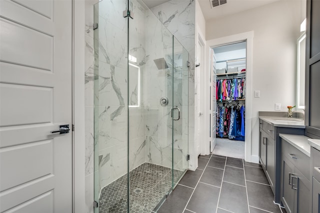 bathroom with vanity, tile patterned flooring, and walk in shower