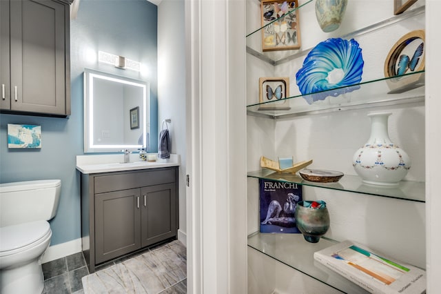 bathroom featuring vanity, toilet, and tile patterned flooring