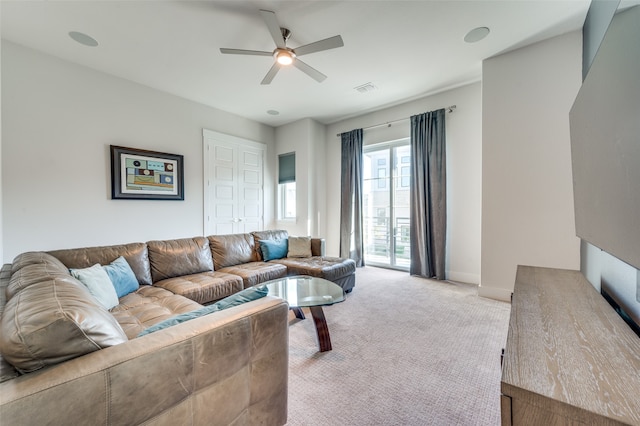 living room featuring light colored carpet and ceiling fan