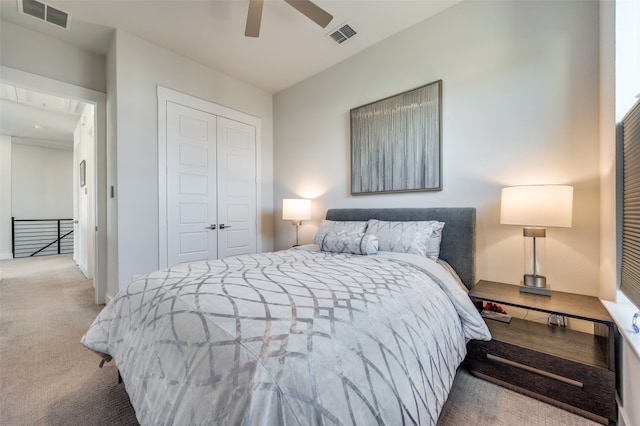 bedroom with a closet, ceiling fan, and light colored carpet