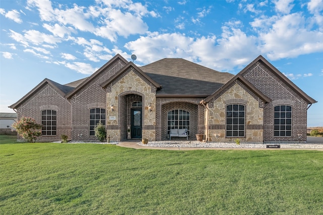 french country home featuring a front yard