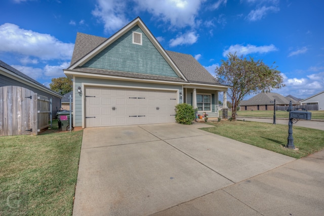 view of front of property with a front yard and a garage