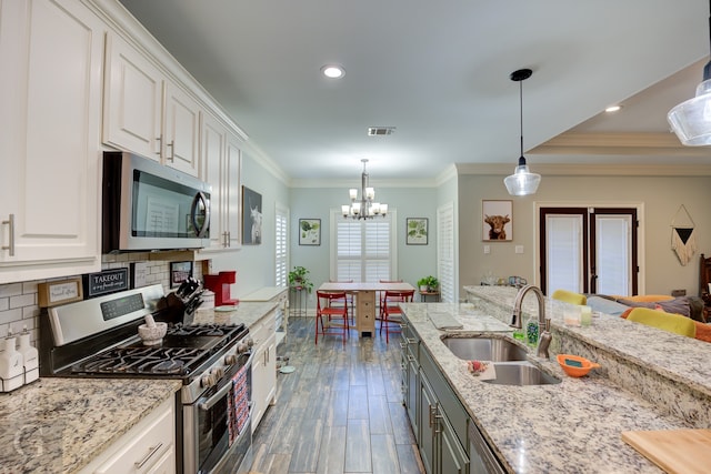 kitchen with decorative backsplash, dark wood-type flooring, sink, white cabinetry, and appliances with stainless steel finishes