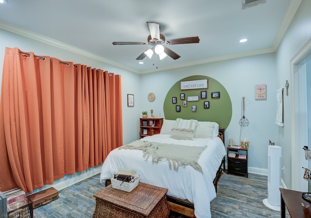 bedroom featuring dark hardwood / wood-style flooring, ornamental molding, and ceiling fan