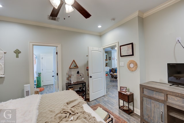 bedroom featuring crown molding, wood-type flooring, and ceiling fan