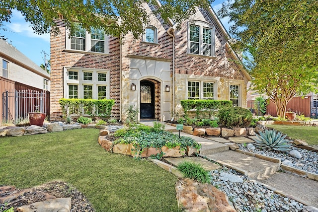 tudor home featuring a front lawn