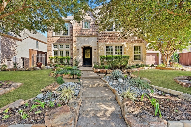 tudor house featuring a front yard