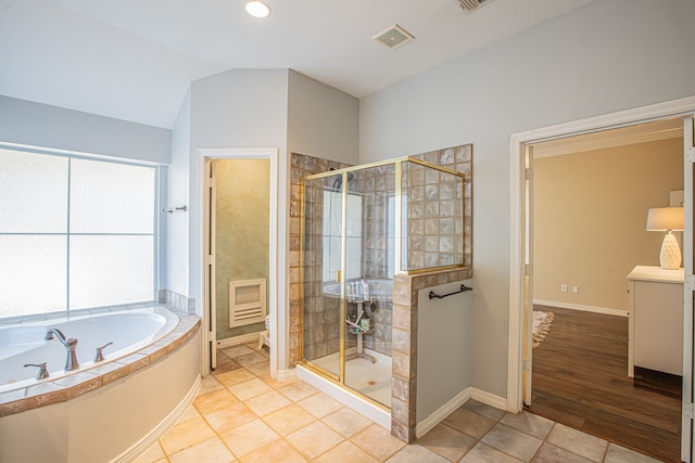 bathroom featuring independent shower and bath, wood-type flooring, and lofted ceiling