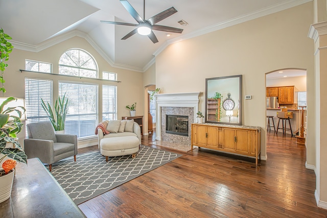 living room featuring crown molding, dark hardwood / wood-style floors, high vaulted ceiling, and ceiling fan