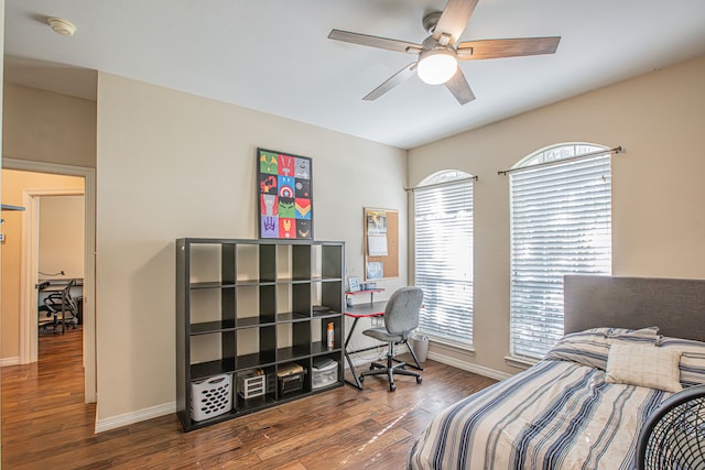 bedroom with dark hardwood / wood-style flooring, multiple windows, and ceiling fan