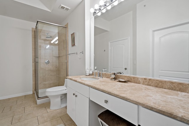 bathroom featuring tile patterned floors, walk in shower, vanity, and toilet