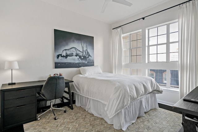 bedroom featuring ceiling fan and multiple windows