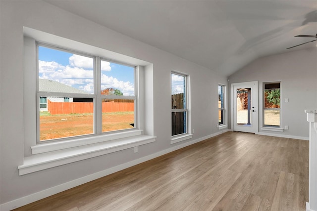 unfurnished room with ceiling fan, light hardwood / wood-style floors, and vaulted ceiling